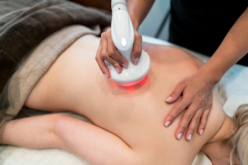 woman getting laser therapy on her back